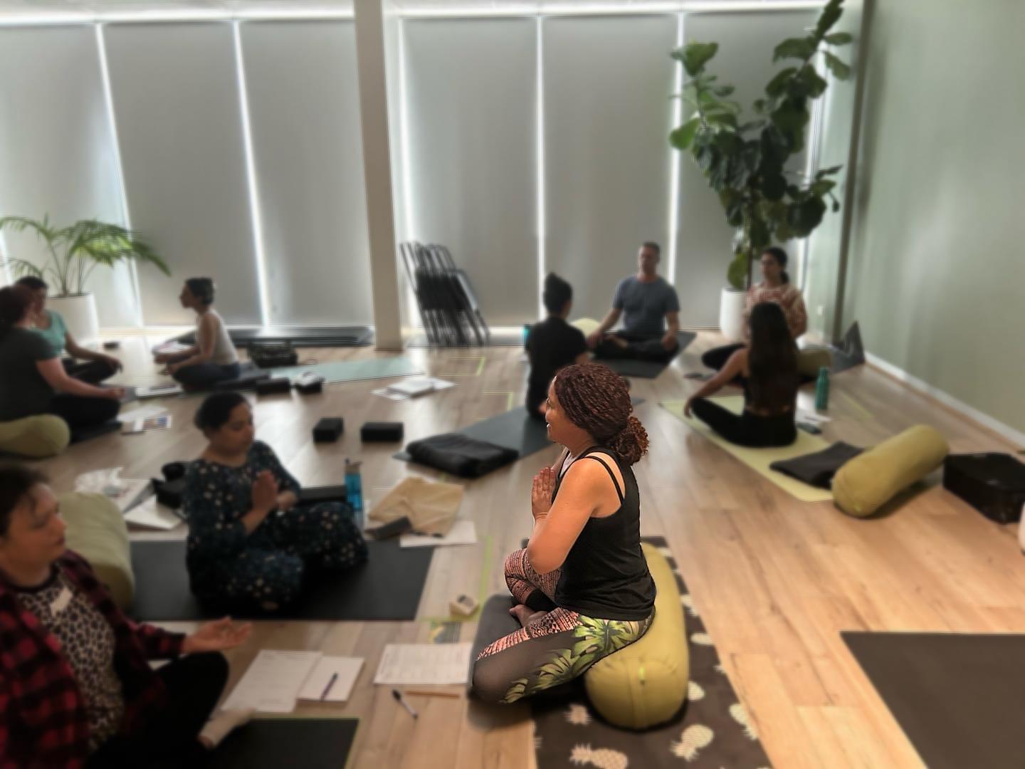 People meditating in a serene yoga studio.